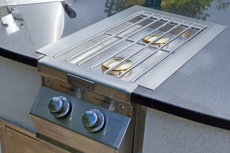 fire magic stainless steel double side burner in an outdoor kitchen